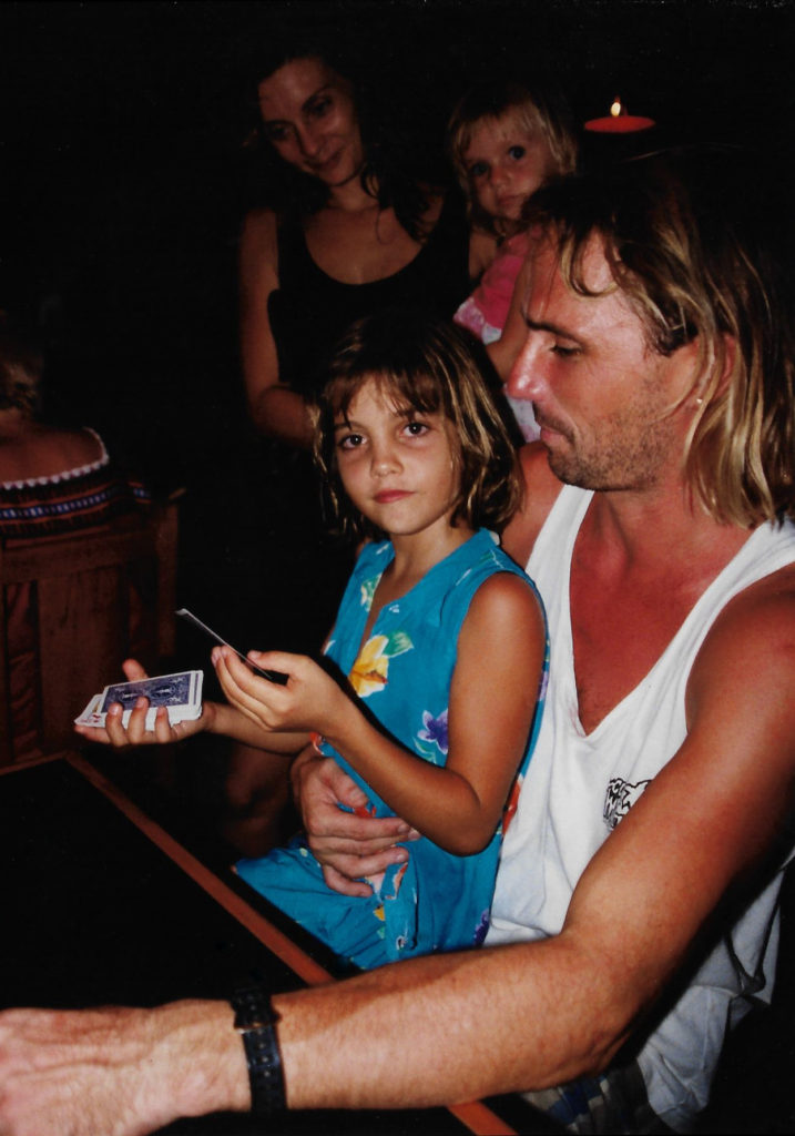 Mike holding his daughter, Jade as she tries to figure out one of my card tricks.
